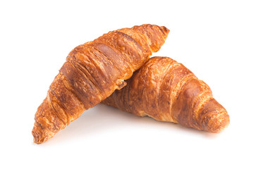 Photo of fresh golden croissants covered sunflower seeds and sesame isolated on white background.