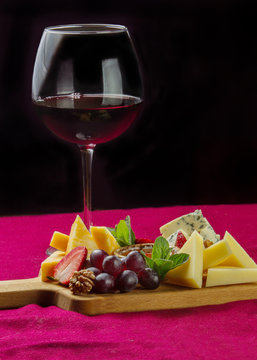 Different kinds of cheese and  glas  of wine