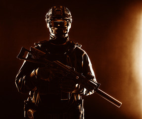 SWAT officer with service rifle low key portrait