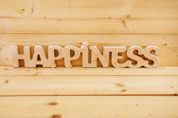 wooden word "happiness" on wooden background