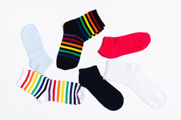 Different colorful textile type of socks on white background. Clothes for legs. Casual style. Top view