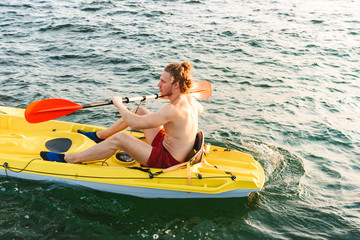 Healthy strong man kayaking