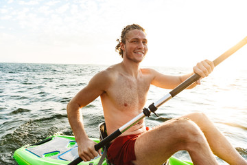Healthy strong man kayaking
