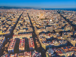 Obraz premium Aerial view of Barcelona Eixample residencial district, Sagrada familia, typical urban squares, Spain.2019