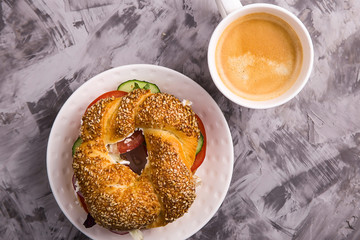 Beautiful and healthy food - a vegetarian sandwich with vegetables and cheese in a bagel