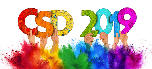 people holding up wooden Christopher street day csd 2019 colorful rainbow lettering holi powder...