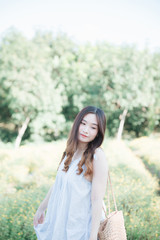 Portrait of Young Asian woman girl smile in flower garden