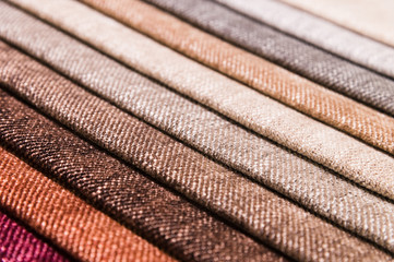 Close-up diagonal lines of textile upholstery in samples to select the color and fabric of the furniture. Abstract multicolored background