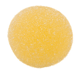 Yellow marmalade ball in sugar isolated on white background close up