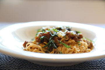spaghetti Bolognese with minced beef and tomato sauce garnished with parmesan cheese and basil , Italian food