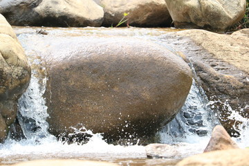 Fototapeta na wymiar Water flow through rock morning time