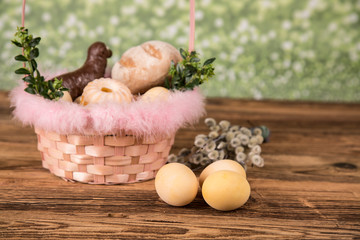 Easter. Colorful palms and base. Foods for Easter candles. Eggs and basket. Easter cake