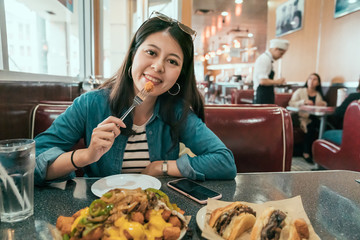 asian local woman lifestyle in usa eating fast food and drinking beverage in American diner...