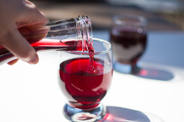 Pouring red wine in a glass