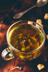 Cup of green tea with brown tea sugar