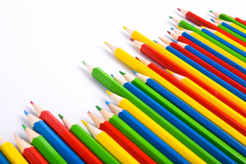 Fototapeta premium Many different colored pencils on a white background with a place for text and cory space .