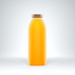 Tall transparent glass bottle filled by orange juice on the white background.