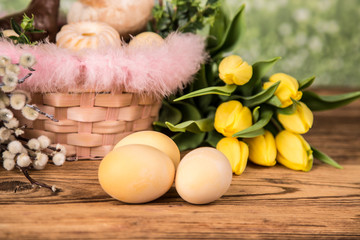 Easter. Colorful palms and base. Foods for Easter candles. Eggs and basket. Easter cake