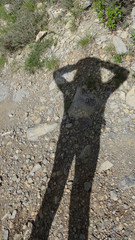 Children shadow on the ground forming a eye with his arms and his head. Eye symbol silouhette