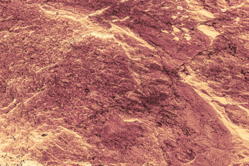 Vintage yellow background. Rough painted wall of aspen gold color. Imperfect plane of golden colored. Uneven old decorative toned backdrop of yellow tint. Texture of gold hue. Ornamental stony surface