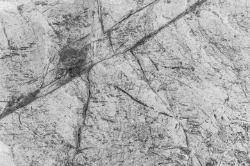 Vintage monochrome background. Rough painted wall of black and white color. Imperfect plane of grayscale. Uneven old decorative backdrop. Texture of black-white. Monochromatic ornamental stony surface