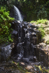 Small waterfall in a forest in Bali, Indonesia with a mini waterfall.