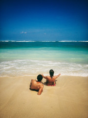 Couple enjoying on a sandy ocean tropical beach.