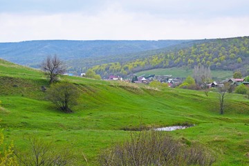 Fototapeta na wymiar Village in the mountains.Beautiful spring landscape.