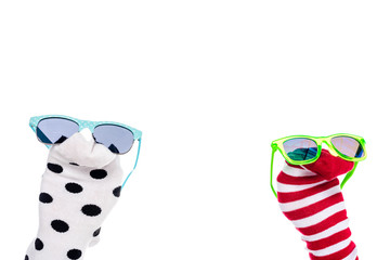 cropped view of person with colorful sock puppets and sunglasses on hands Isolated On White