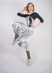 beautiful caucasian girl wearing futuristic pvc corset and plaid metallic skirt with mirrored...