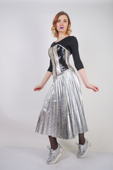 beautiful caucasian girl wearing futuristic pvc corset and plaid metallic skirt with mirrored...