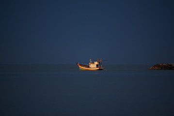 Obraz premium A fisherman boat on blue sky background