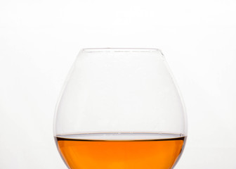 brown alcohol drink in crystal glass isolated on white