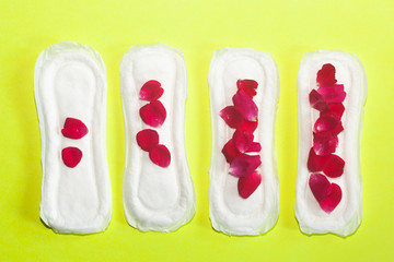 Female's hygiene products on yellow background. Concept of critical days, menstrual cycle, period days, PMS