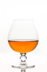 transparent glass on stem with brown drink isilated on white