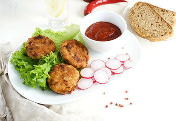 Homemade fried chicken meat cutlets with salade leaves , lettuce and sauce top view