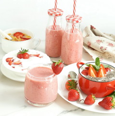 Strawberry smoothie or milkshake in a glass on marble background. Healthy food for breakfast and snack. copy space