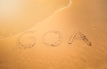 Finger drawn on the sand word Goa, India