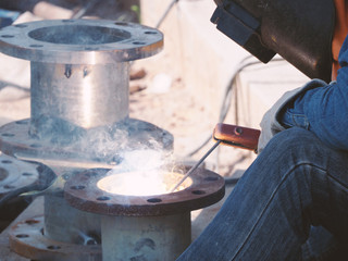 Welding work ,worker with protective welding metal on construction