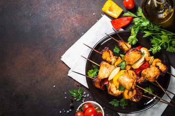 Chicken kebab with vegetables on skewers top view.