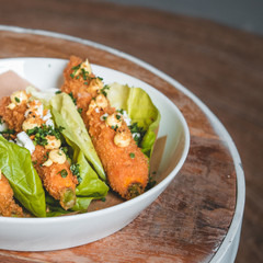 Delicious vegeterian tapas dish with fried carrots wrapped in lettuce
