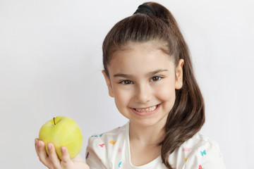 Fototapeta premium Happy adorable child girl with apple. Smile, healthy teeth, dentistry. 