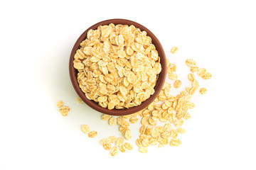 Top view of Bowl full of flaked oats on a white background