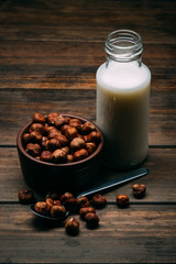 Hazelnut milk isolated on a wood background, vegan milk