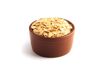 Bowl full of flaked oats on a white background