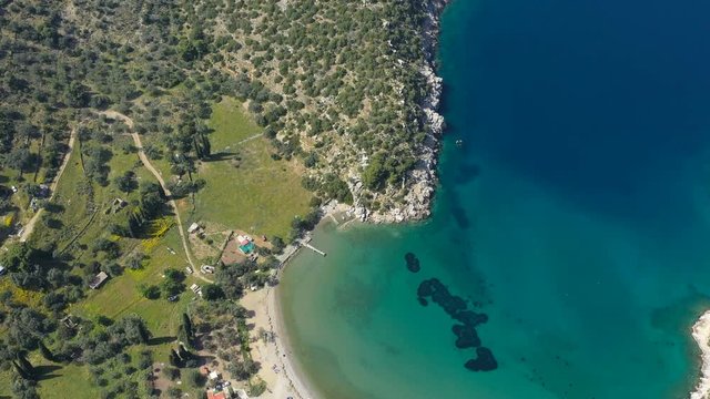 Aerial video of Greek island Poros. Vagionia bay. Paralia Vagonia. Blue water and hills. Epic panaramic footage. 4K