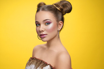Charming girl with great makeup looking at camera in studio