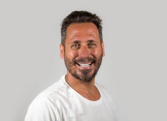 Obraz premium portrait of young happy and attractive man with blue eyes and beard looking cool smiling happy and confident wearing white t-shirt isolated on studio background