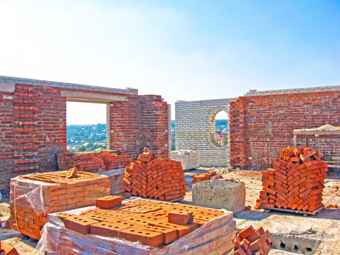 Construction of a multistory building. Brick and walls and ceilings of the unfinished floor