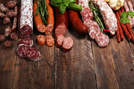 cold meat assortment with delicious salami and  fresh herbs . Variety of meat products including coppa and sausages
